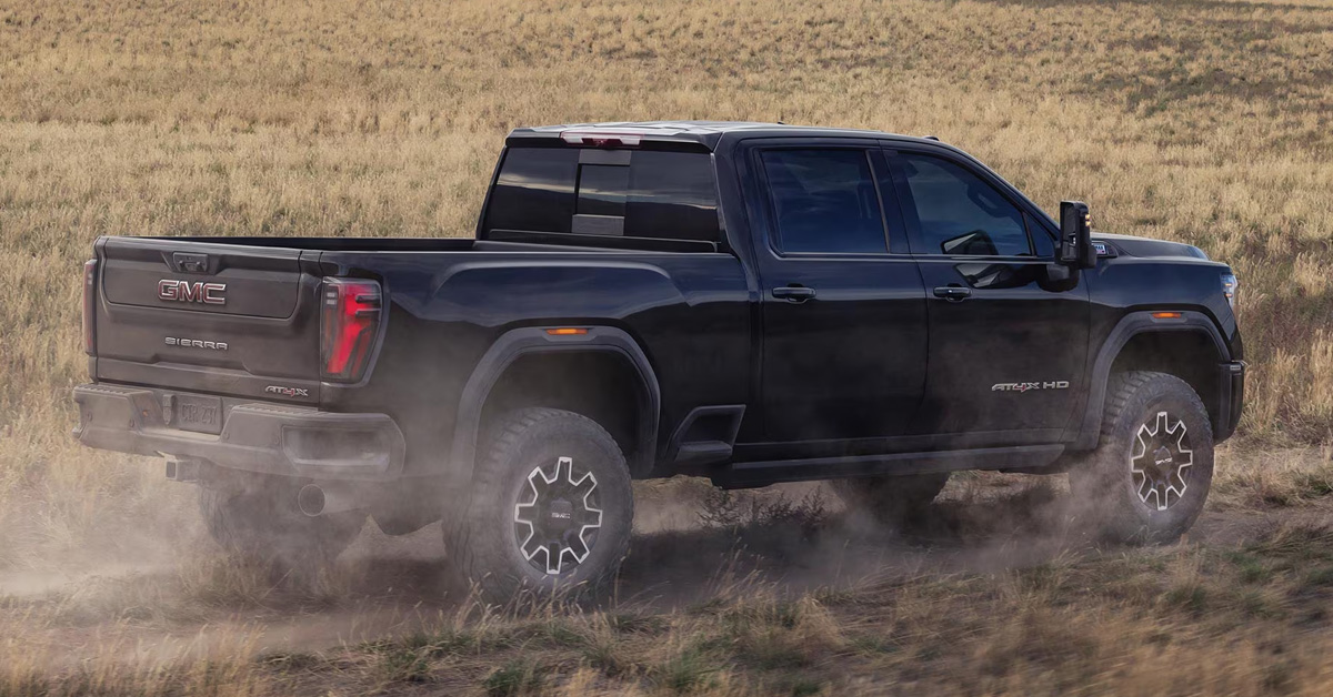 2026 GMC Sierra HD driving in a sandy terrain